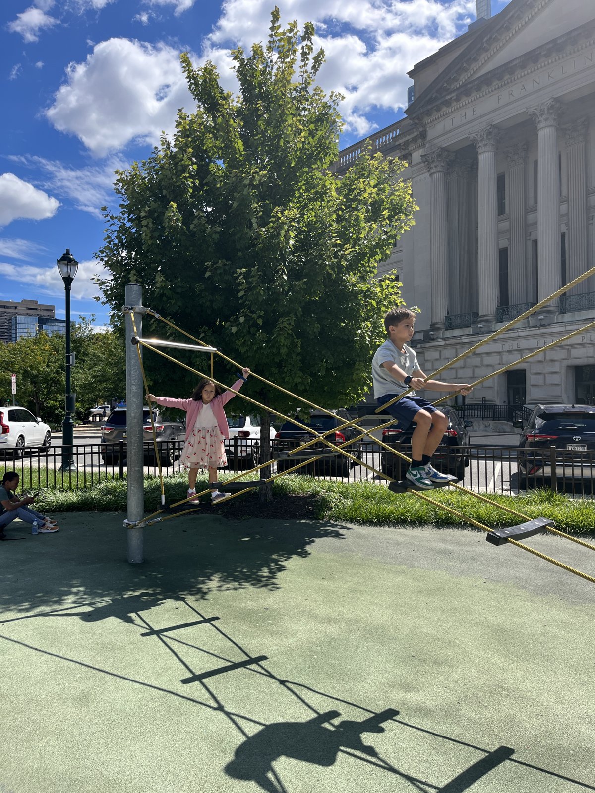 Oliver and Annabel climbing at a playground